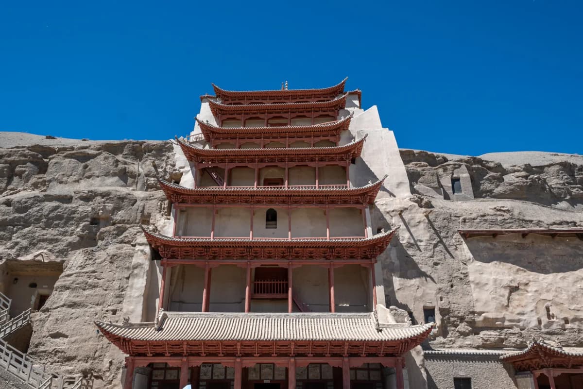 Cliff face of the Mogao Caves near Dunhuang, honeycombed with Buddhist cave temples carved over a thousand years