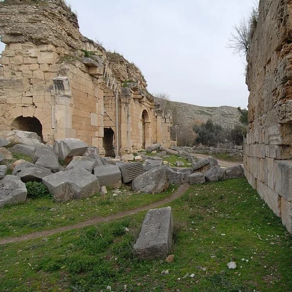 The Roman triumphal arch at Anavarza with the massive castle cliff behind