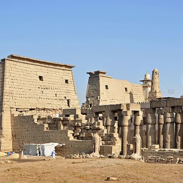 The colonnaded forecourt of Luxor Temple illuminated at night, Luxor, Egypt