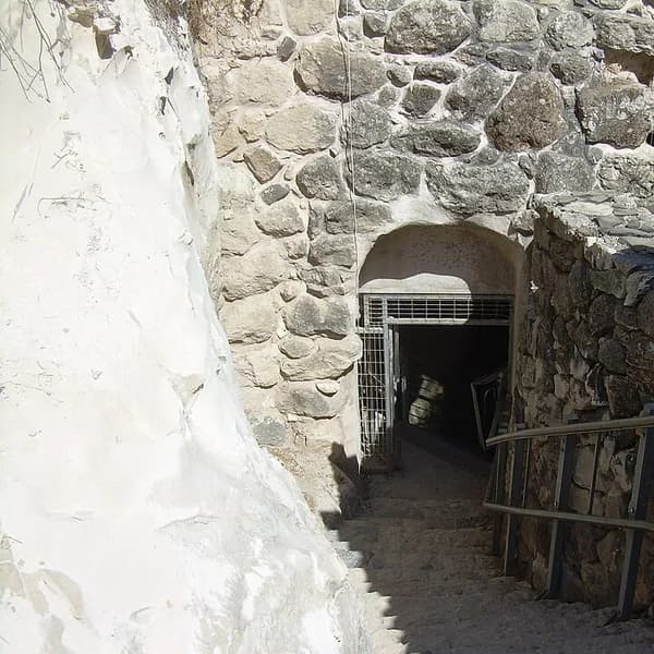 Excavated stone walls and spoil of Tel Megiddo overlooking the Jezreel Valley