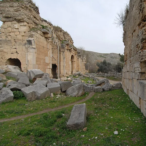 The Roman triumphal arch at Anavarza with the massive castle cliff behind